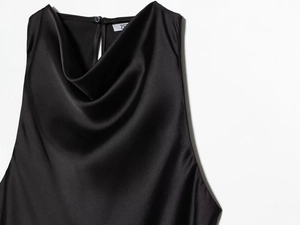 Detail of elegant black satin cowl neck top featuring a smooth texture and back button closure