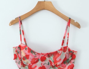 Detail of red strawberry print camisole featuring wire cups and delicate lace trim