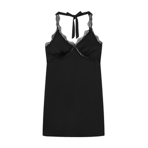 Detail of elegant black lace patchwork on a satin halter dress with a deep V-neckline