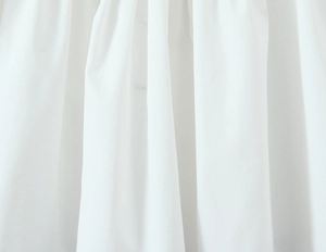 Close-up of premium white twill fabric detail showing soft texture and natural drape