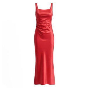 Detail of red satin dress featuring refined side pleating and elegant silk texture