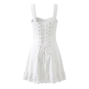 Detailed back view of white lace-up dress featuring delicate lace trim and embroidery