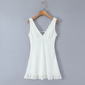 Close-up of white lace mini dress with deep V-neckline and delicate floral embroidery