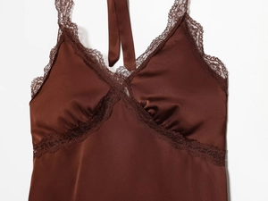 Detail of coffee brown satin camisole with delicate lace trim and pleated V-neckline