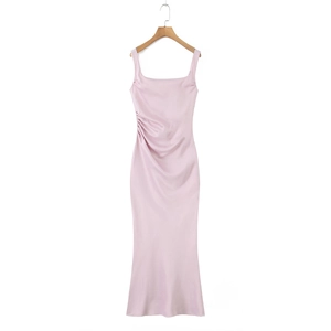 Detail of light pink satin dress showing elegant side ruching and silky fabric texture