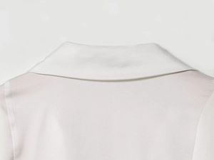 Detail of the smooth lapel collar on a white satin shirt showing premium fabric texture