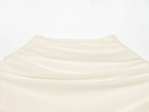 Detailed macro view of layered white mesh fabric with elegant pleated texture and ruffled trim