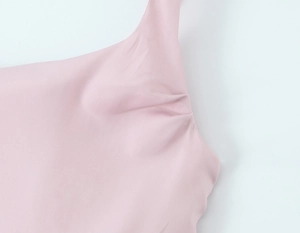 Detailed close-up of pink dress ruching and high-elasticity fabric texture