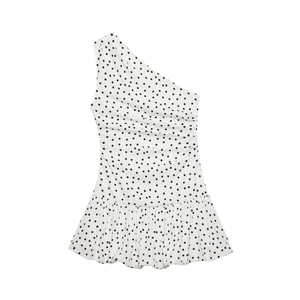 Detail of one-shoulder summer dress with black polka dots and side ruffle hem design