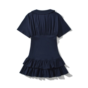 Detail view of navy blue dress with pleated back and layered ruffle hemline