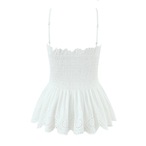 Detailed view of white smocked crop top with delicate floral eyelet embroidery details