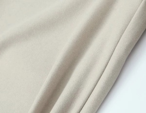 Gros plan sur le tissu en cachemire beige montrant une texture et des fibres de qualité