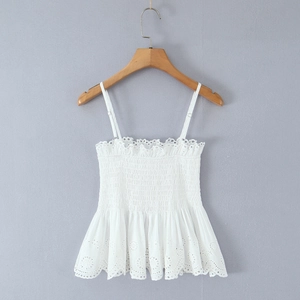 Close-up of white cotton camisole with detailed smocking and eyelet embroidery