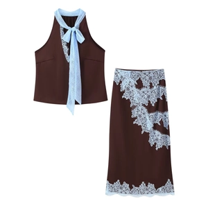 Detailed close-up of dark brown two-piece set featuring delicate blue lace trim details