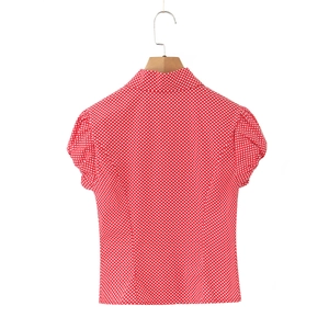 Detail view of red polka dot short sleeve shirt with slim fit back waist design