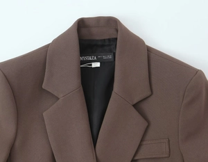 Detail of coffee brown blazer collar with black satin lining and size labels