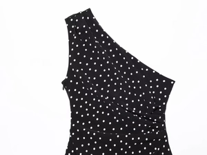 Detailed view of polka dot dress with one-shoulder design and invisible side zipper