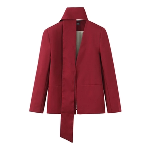 Close-up of wine red blazer with elegant scarf tie collar and high-quality fabric texture