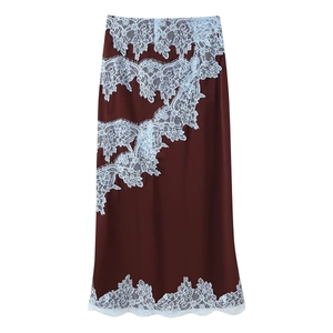 Detailed view of dark burgundy satin skirt with white eyelash lace floral patchwork