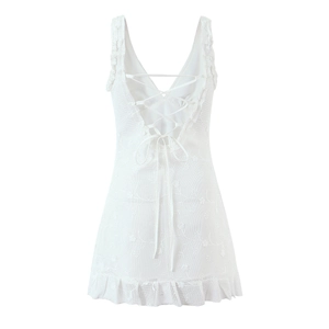 Detailed back view of white lace mini dress with cross-over lace-up straps and ruffle hem