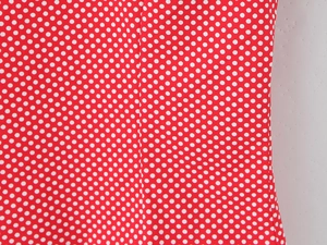 Detailed macro view of red fabric with white polka dot pattern for summer set