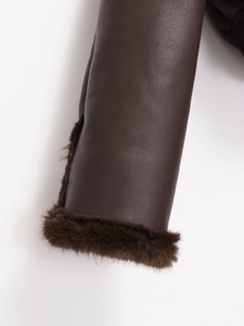 Detail of dark brown leather jacket cuff featuring plush faux fur lining and trim