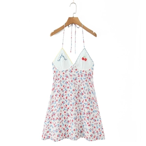 Detail of floral halter dress featuring colorful scalloped edges and cherry embroidery
