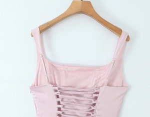 Detailed back view of a pink fishtail dress with lace-up straps and a side zipper