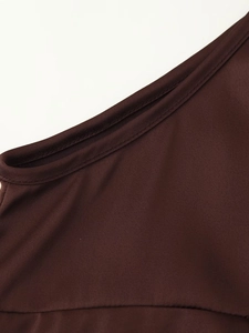 Macro detail of dark brown lace vest neckline featuring precise double-needle stitching