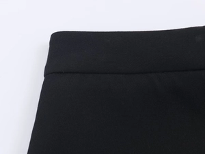 Détail de couture à la taille et texture du tissu tissé sur un pantalon noir droit