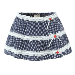 Detail of navy blue polka dot skirt featuring white lace trim and red rose bows