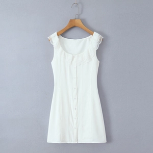 Detailed view of white sleeveless dress showing lace collar and white front buttons