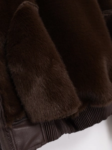Detail of faux fur texture and ribbed leather hem on this dark coffee jacket