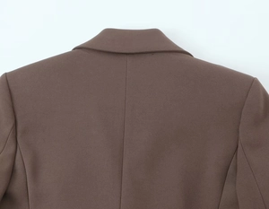 Detail of shoulder and collar stitching on chocolate brown twill fabric blazer