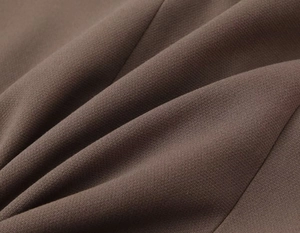 Macro view of dark brown woven fabric texture for a high-quality fashion suit set