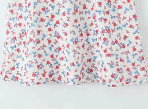 Close-up of lightweight chiffon floral dress hem with fine stitching and colorful print