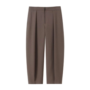 Detail of dark brown high-waisted wide-leg trousers with elegant front pleats and zipper