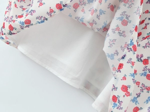 Close-up of floral print fabric detail and layered hemline sewing of the summer dress