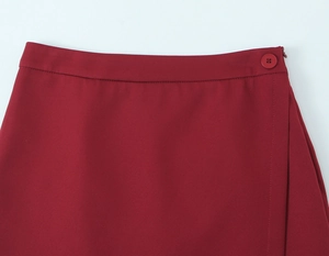 Detailed close-up of wine red mini skirt waist with matching buttons and invisible zipper