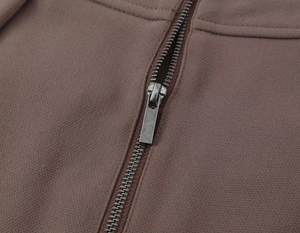 Macro shot of durable metal zipper hardware and woven fabric texture on a suit set