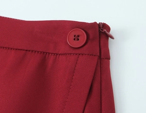 Detail of red blazer set featuring high-quality resin button and invisible zipper waist line