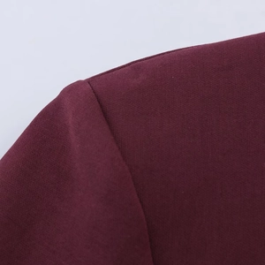 Close-up of shoulder seam and burgundy fabric texture on a slim fit short sleeve dress