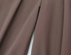 Macro view of taupe suit fabric texture showcasing high drape and premium fiber detail