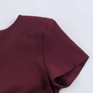 Detailed macro view of wine red short sleeve cuff with premium rolled edge stitching