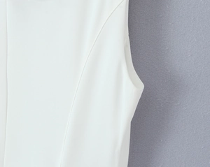 Detailed close-up showing princess seams and armhole stitching on a white summer dress