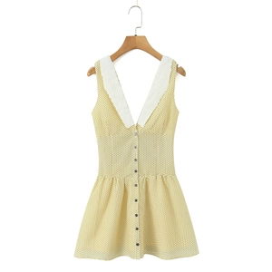 Detail view of yellow polka dot dress with embroidered white collar and button front