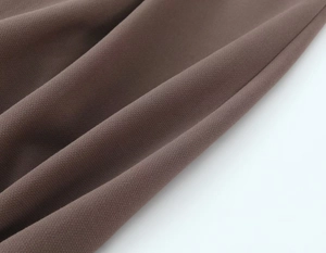 Detailed macro view of dark brown high-quality twill fabric for women suits