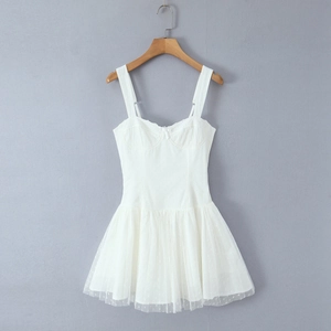 Detail of white mesh mini dress with lace trim, polka dot embroidery and a small bow