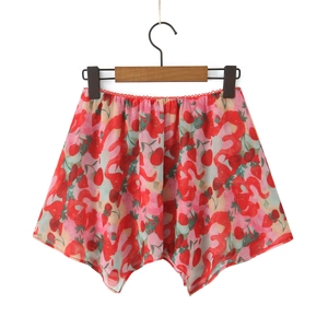 Detail of summer strawberry print skirt with irregular hem and pleated elastic waist