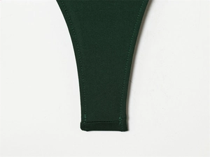 Detailed close-up of dark green knitted bodysuit stitching and double-needle hem texture